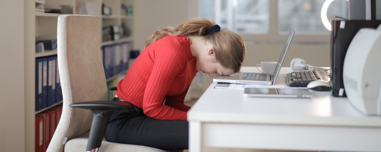 woman with head on desk