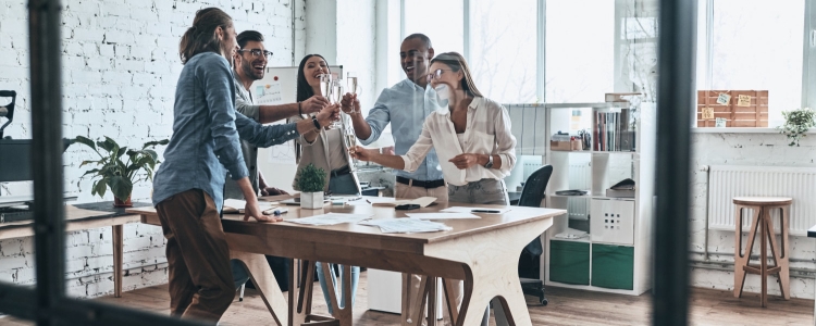 people celebrating in an office conference room