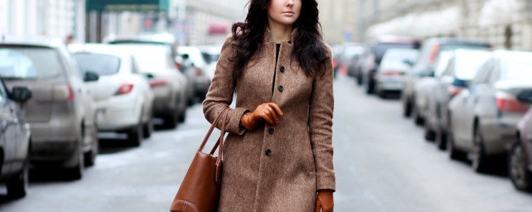 professional young woman walking down a street wearing a stylish interview coat