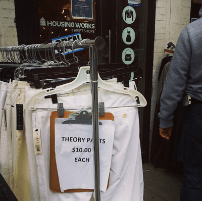 rack of all-white pants with sign, "Theory pants $10 each" outside Brooklyn Housing Works Thrift Shop