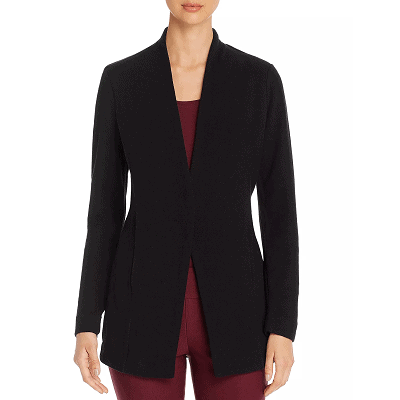 woman wears black sweater jacket without collar, she wears an all-burgundy work outfit beneath it
