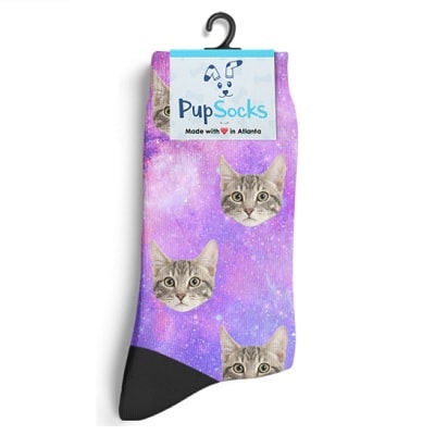 Galaxy-print socks with a gray cat face in a repeating pattern