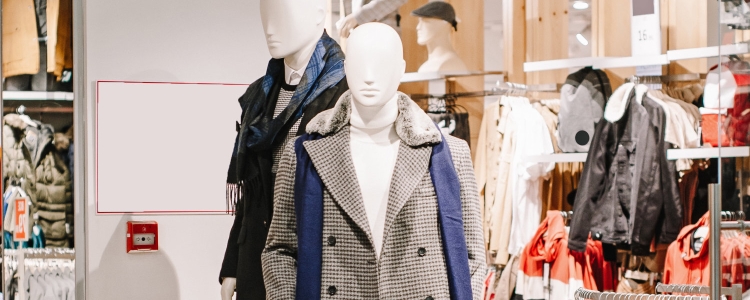 mannequins in a store wearing winter coats for work