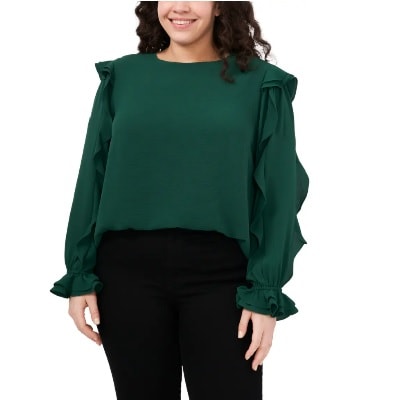 A woman with long black hair wearing a green long-sleeved shirt with black pants