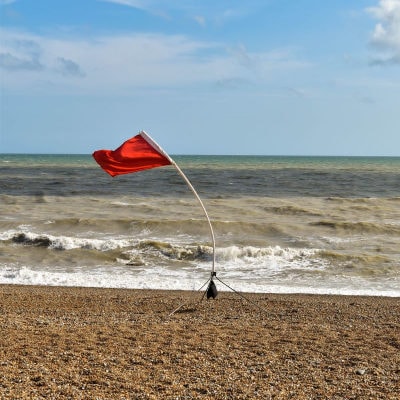 red flag waving on beach
