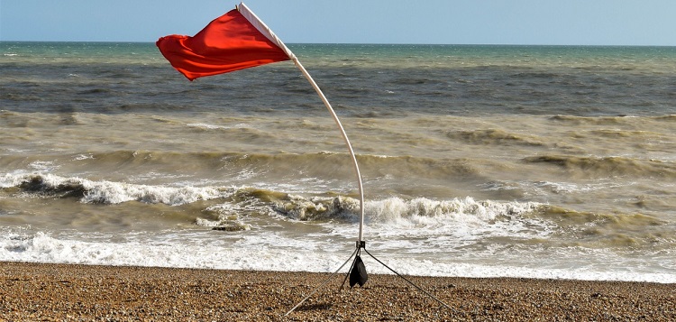 red flag waving on beach