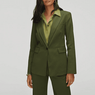 professional woman wearing an olive green blazer, olive green trousers and a lighter green olive blouse