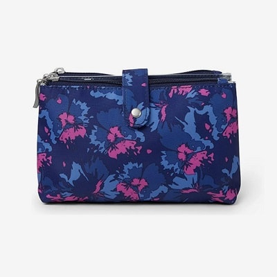 A closed toiletry case with a floral print of navy, blue, and pink 