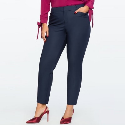 plus-size work pant; woman wears navy pants with red heels and reddish shirt