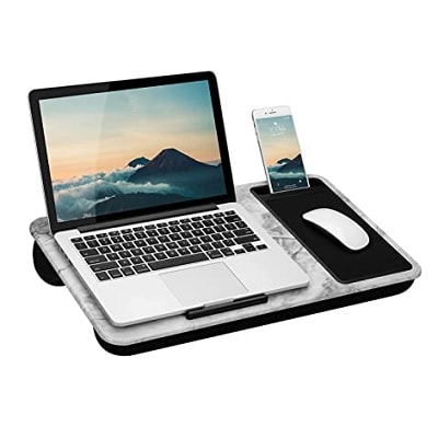 A gray lap desk with a laptop, white mouse, phone, and black mousepad on it