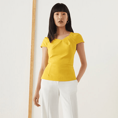 yellow blouse with fold details at neckline