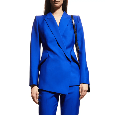 professional woman wears an electric blue blazer with asymmetric details, with cigarette trousers