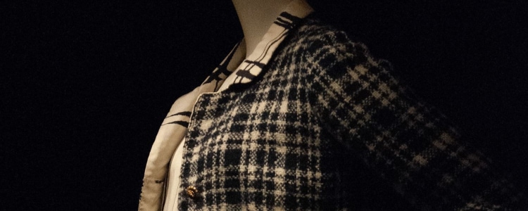 tweed, Chanel-like jacket on a mannequin; there's a contrasting plaid on the inside of the jacket. 