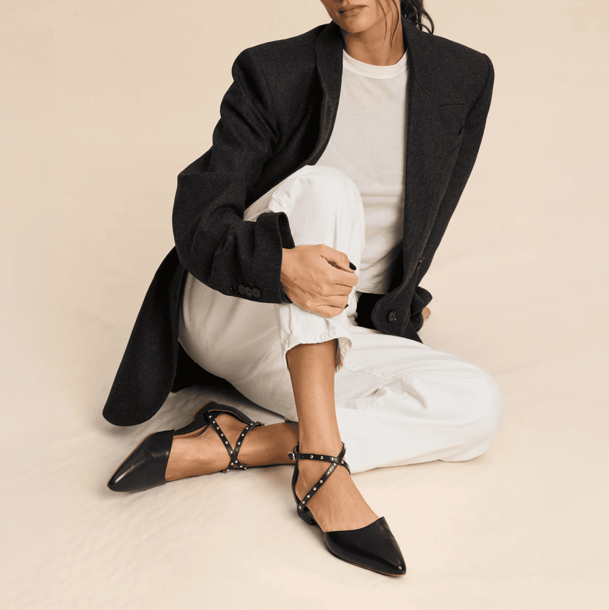 woman in blazer wears sophisticated strappy flats for work
