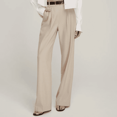 woman wears wide legged beige pants