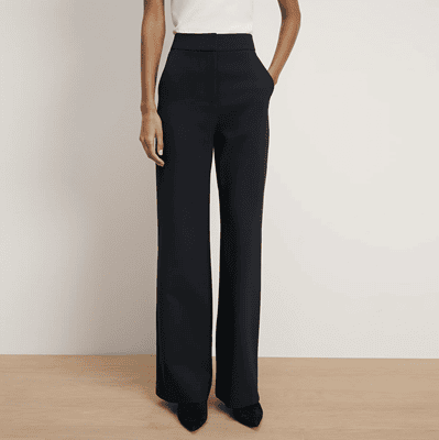 woman wears stylish black wide leg trousers