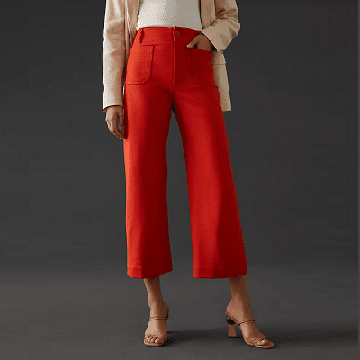 woman wears bright red ponte cropped wide leg pants with large patch pockets on the front