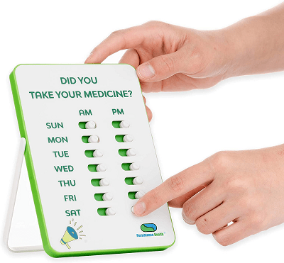 a white and green chart that reads "DID YOU TAKE YOUR MEDICINE?" with columns with the days of the week and AM/PM; a woman is sliding over a tab for Saturday PM.