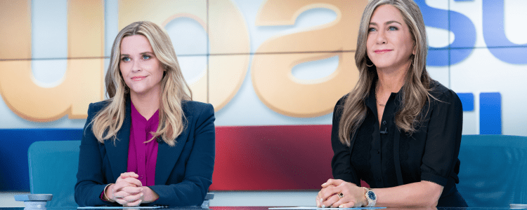 screenshot from The Morning Show featuring Reese Witherspoon and Jennifer Aniston in character as news anchors