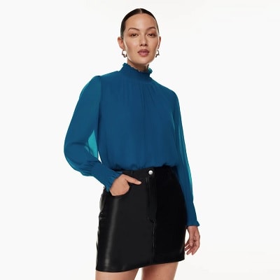 blue turtleneck blouse with ruffled sleeves