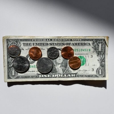 dollar bill with coins on top of it