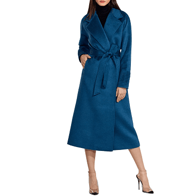 woman wears a long alpaca wrap coat in an Atlantic blue; there are linear ribbed details on the cuffs and a general sheen to the coat