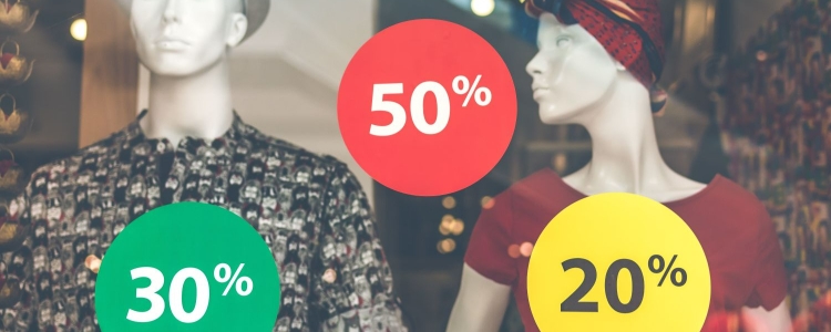 store mannequins in shop window; colorful signs read 30%, 20% 50%