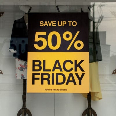 sign in shop window says SAVE UP TO 50% BLACK FRIDAY NOW IS THE TIME TO SAVE!