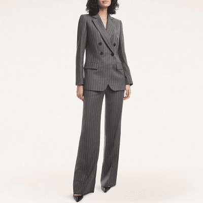 woman wears double-breasted pinstriped charcoal pantsuit
