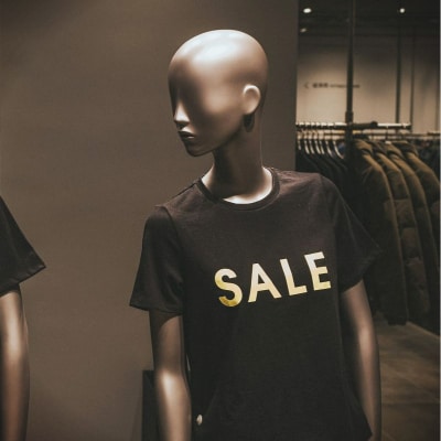 store mannequins wear t-shirts that say SALE