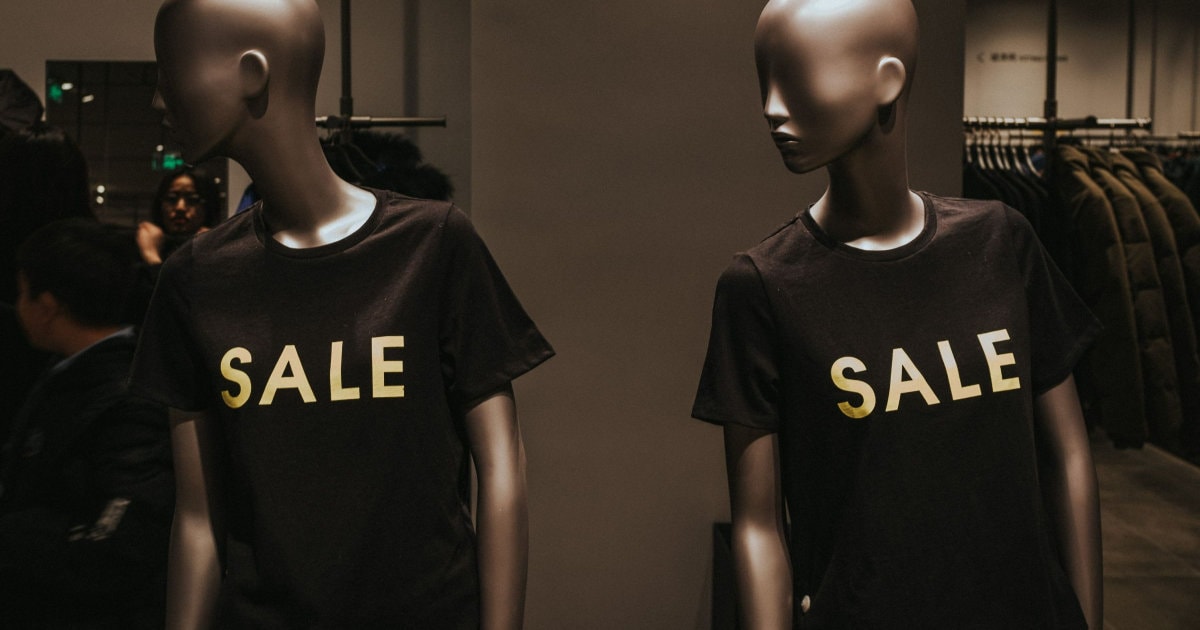 store mannequins wear t-shirts that say SALE