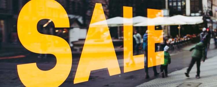 Big yellow letters read SALE in the shop window