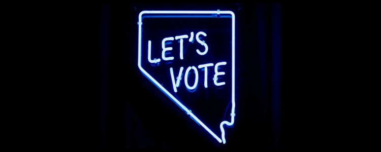 neon sign reads "LET'S VOTE"