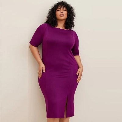 A woman in a purple bodycon dress