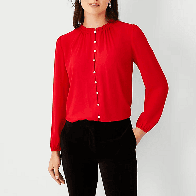 red blouse with ruffled neck, elastic cuffs, and pearlized buttons