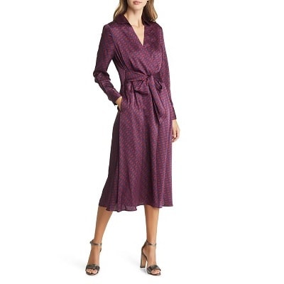 A woman wearing a navy/maroon shirtdress with silver heels
