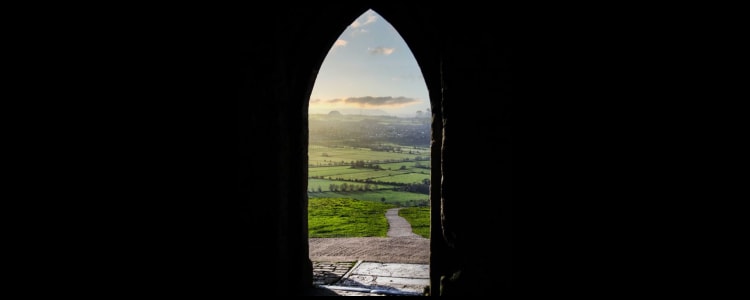 view of dawn of a new day from an arched doorway