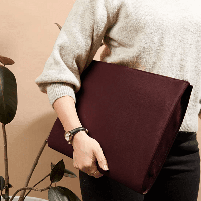 woman carries burgundy gusseted document and laptop holder