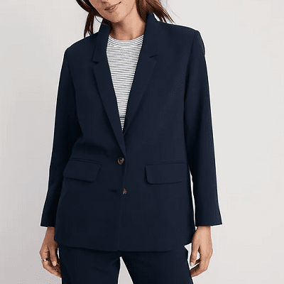 woman wears boxy navy crepe pants suit