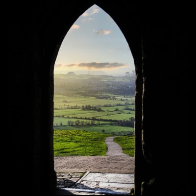 view of dawn of a new day from an arched doorway