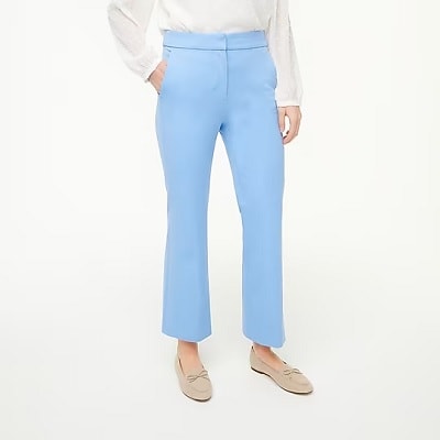 a woman wearing sky blue pants and beige flats