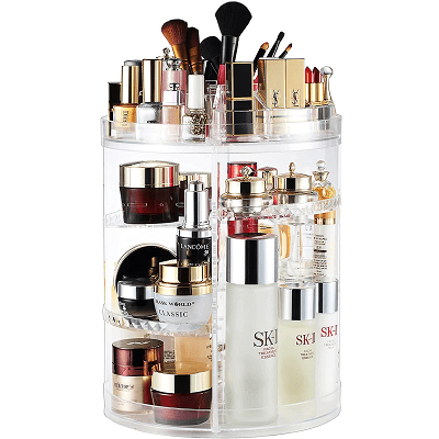 rotating clear acrylic tower with lots of makeup bottles on it; the middle shelf is an adjustable height