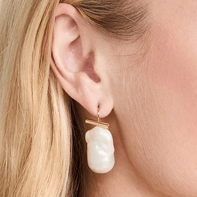 pearl earrings with gold bar at top of elongated organic pearl shape