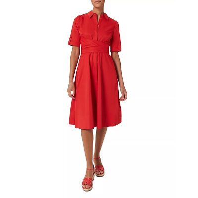 A woman wearing a red shirtdress and red sandals