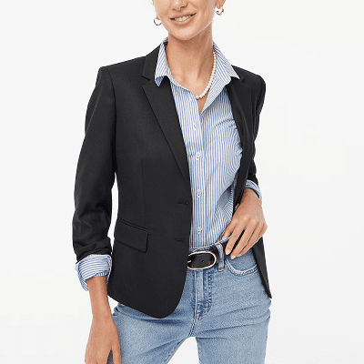 shrunken schoolboy blazer, worn with jeans, a black belt, a stripey blue blouse and a pearl necklace