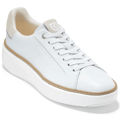 white sneakers with beige lining around the sole