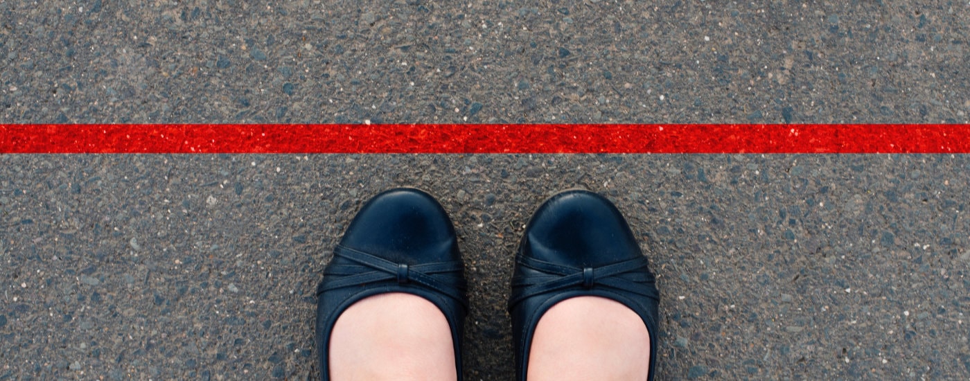 woman's ballet flats are close to a red boundary line