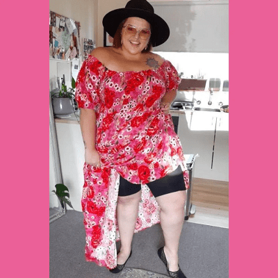 Plus size woman in red dress showing off her refreshing shorts.