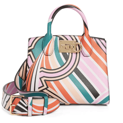colorful boxy handbag with gold lock detail on the front; the pattern is swooping lines of pink, orange, beige, black, and teal green