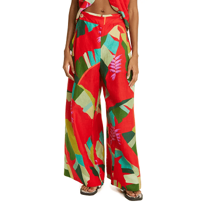 bright red linen pants with green tropical foliage and pink heliconia flowers  